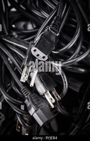 Black power cables cords in a pile (US 3-Prong For PC server many electric home office industrial appliance) Stock Photo