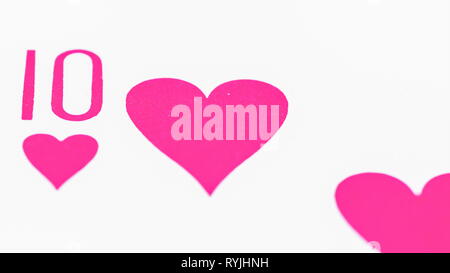 The ten hearts of cards on a macro shot with the pink colored hearts on a white card Stock Photo