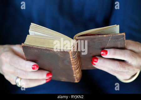 Woman reading and old christian book. Close-up. Stock Photo