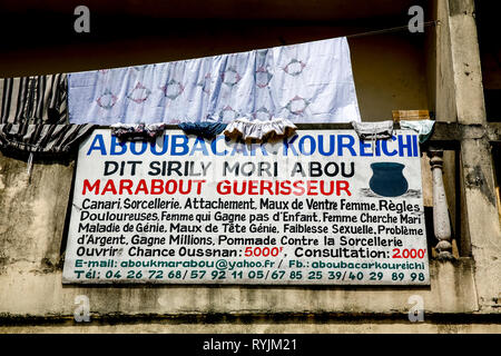 Healer's sign in Abidjan, Ivory Coast Stock Photo