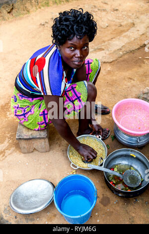 Village woman cooking near Agboville, Ivory Coast. Stock Photo