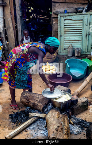 Village woman cooking near Agboville, Ivory Coast. Stock Photo