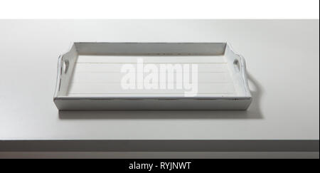 White tray on table top view macro. Vintage wooden tray with wooden handles in kitchen Stock Photo
