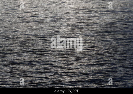 Water surface with ripples texture background, viewed from above in black and white. Norway. Stock Photo