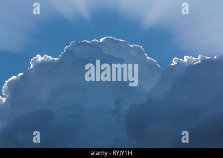 The sun behind the cloud. The sun's rays pass through the clouds Stock Photo