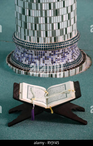 Mubarak mosque.  An open Holy Quran and a muslim prayer beads on wood stand  Chau Doc. Vietnam. Stock Photo