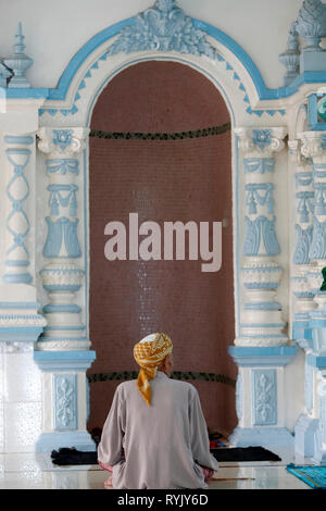 Masjid Nia'mah mosque.  Muslim man praying in front of the  mihrab. Chau Doc. Vietnam. Stock Photo