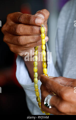 Muslim man holding islamic prayer beads. Close-up.  Chau Doc. Vietnam. Stock Photo