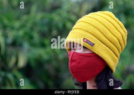 Young woman wearing a pollution  mask.  Dalat. Vietnam. Stock Photo