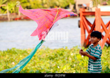 Young boy flying his kite.  Cai Be. Vietnam. Stock Photo