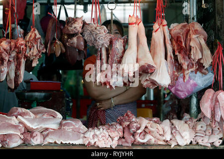 Cuts of meat hanging on hooks at a traditional market butcher shop.  Ha Tien. Vietnam. Stock Photo