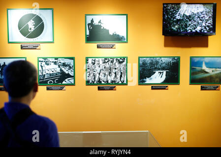 War Remnants Museum. Visitor looking at shocking photos from war.  Ho Chi Minh City. Vietnam. Stock Photo