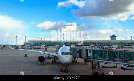 MUNICH, BAVARIA, GERMANY - MARCH 13, 2019: Lufthansa Airbus A350-900 Bochum at Munich Airport. Front view of twin-engine airliner with jet bridge. Stock Photo