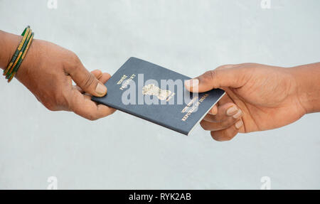 Concept of woemn receving passport at the door step of the house in India Stock Photo