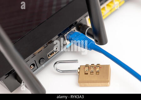 Network and data protection concept with padlock. Internet router or switch with cable plugged in. Stock Photo