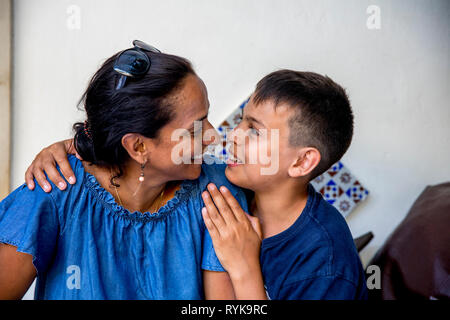 Smiling mother and son looking at each other in Taormina, Sicily (Italy). Stock Photo