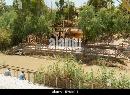 Qasr el Yahud,ISrael,25-,may-2010: people sitting at the Baptismal site Qasr el Yahud on the Jordan river is according to the bible the place where Jesus Christ is being baptized by John the baptist Stock Photo