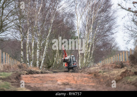 Kubota KX 161-3 mini excavator operating along a moorland track. Stock Photo