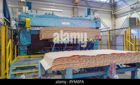 Pile of thin sheets of woods on the sawmill factory on the top of a machine ready to be processed Stock Photo