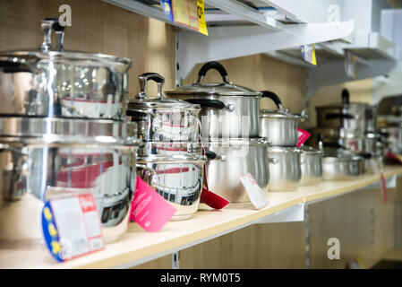 A set of stainless steel utensils on the shelves of the store, close-up Stock Photo