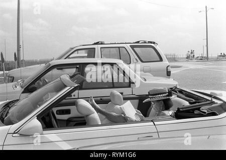 Lake Worth  Florida 1990s. Woman reading a book in open top sports car Lake Worth USA 1999 HOMER SYKES. Stock Photo