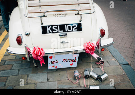 back of a vintage wedding car with just married sign and tin cans. British wedding Stock Photo