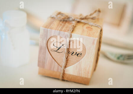 small rustic wedding favour box with Love written on tied with string Stock Photo