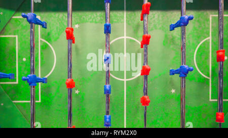 The top view of the red and blue players on table soccer found inside the living area of the cruise ship Stock Photo
