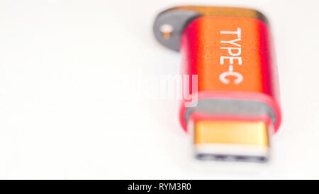 The Type C USB-C micro adapter port on the table that is red in color Stock Photo