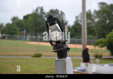 Broken lantern on a post Stock Photo