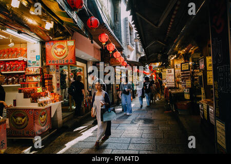 Jiufen, Taiwan - November 07, 2018: A young woman walks with purchases at the Old Street market on November 7, 2018, in Jiufen, Taiwan Stock Photo