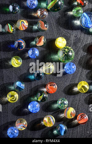 Glass marble balls and shadows on table Stock Photo