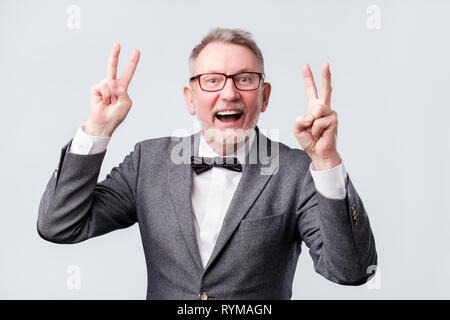 happy senior man making the victory or peace hand sign Stock Photo