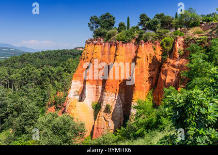 Beautiful red ocher cliffs near the village of Roussillon, France. Stock Photo