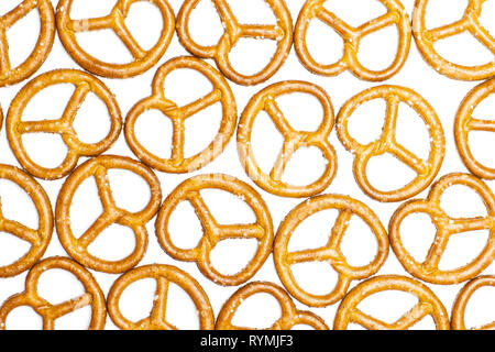 Lot of whole mini salted pretzels flatlay isolated on white background Stock Photo