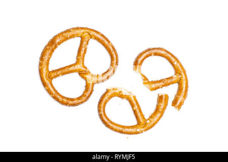 Group of one whole two halves of mini salted pretzels flatlay isolated on white background Stock Photo