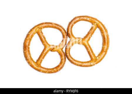 Group of two whole mini salted pretzels flatlay isolated on white background Stock Photo