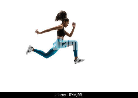 Young african woman running isolated on white studio background. One female runner or jogger. Silhouette of jogging athlete Stock Photo