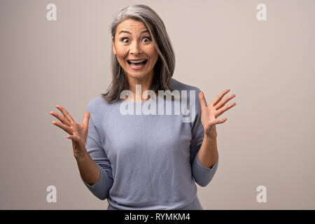 Beautiful mature woman is making funny faces Stock Photo