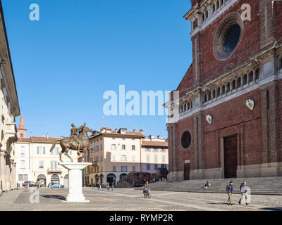 PAVIA, ITALY - FEBRUARY 22, 2019: people walk near monument Regisole and Cathedral on Piazza del Duomo. Pavia is town in Lombardy, the city was the ca Stock Photo