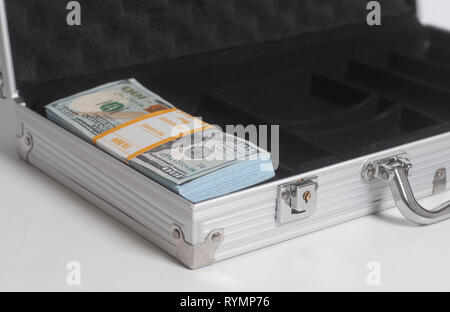 Open suitcase with hundred dollar bills stack on white background Stock Photo