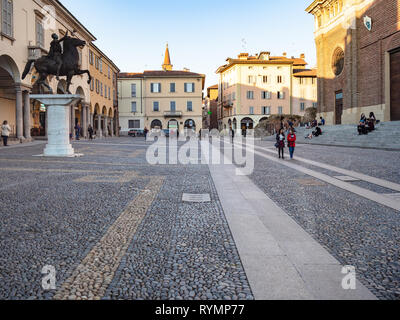 PAVIA, ITALY - FEBRUARY 22, 2019: people walk on Piazza del Duomo in Pavia city in evening. Pavia is town in Lombardy, the city was the capital of Kin Stock Photo