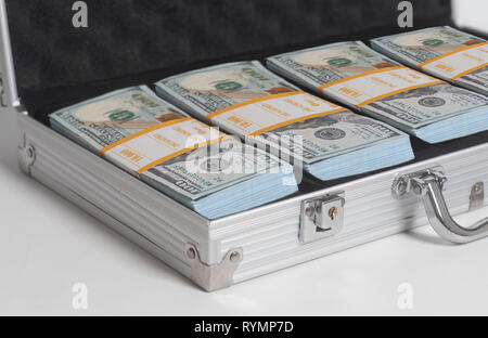 Open suitcase with hundred dollar bills stacks on white background Stock Photo