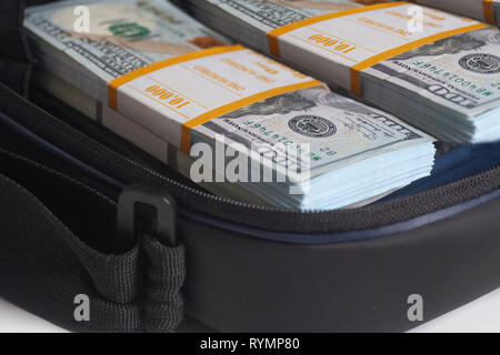 Open briefcase with hundred dollars bills stacks on white background Stock Photo