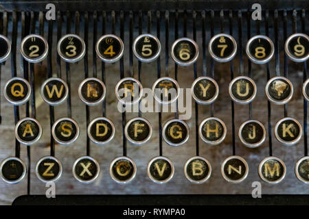 Old typewriter keyboard with silver and black round keys Stock Photo