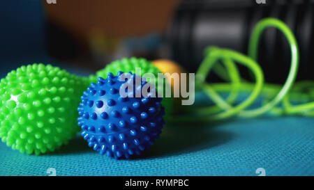 Massage ball and roller for self massage, reflexology and myofascial release, blue background. Equipment for sports, yoga, fitness Stock Photo