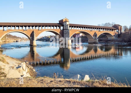 Travel to Italy - view of Ponte Coperto (Covered bridge, Ponte Vecchio, Old Bridge), brick and stone arch bridge over Ticino River in Pavia city, Lomb