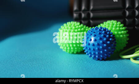 Massage ball and roller for self massage, reflexology and myofascial release, blue background. Equipment for sports, yoga, fitness Stock Photo