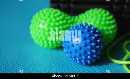 Massage ball and roller for self massage, reflexology and myofascial release, blue background. Equipment for sports, yoga, fitness Stock Photo