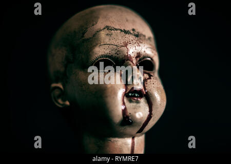 Creepy bloody doll in the dark Stock Photo